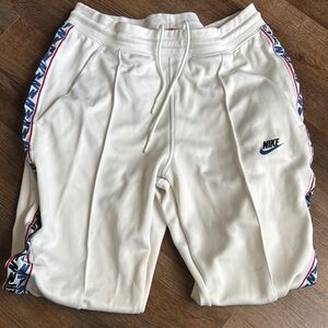 Nike White Joggers with Soft Fleece and Side Stripes snapped leg
